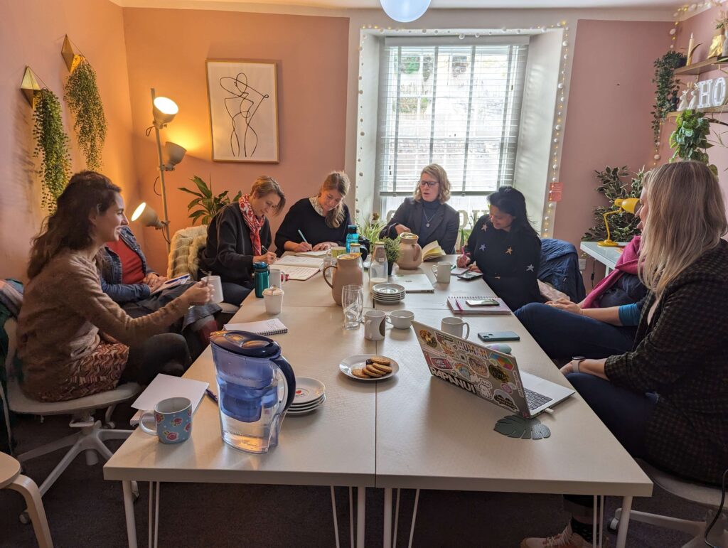 women sat around a table at a marketing workshop at The Tribe Coworking Space in Totnes