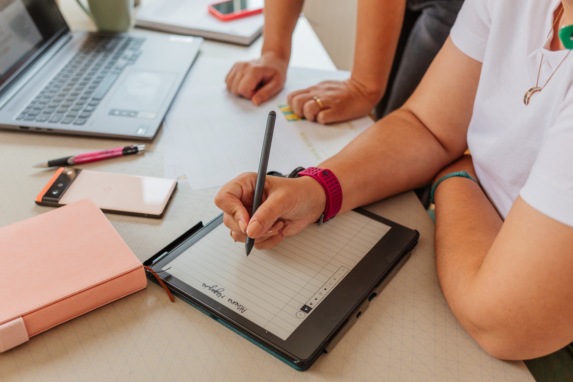 Two women planning content for their business